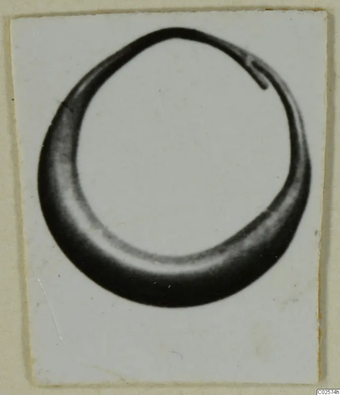 Ring from Enkomi, shown in a photograph mounted on a white card.