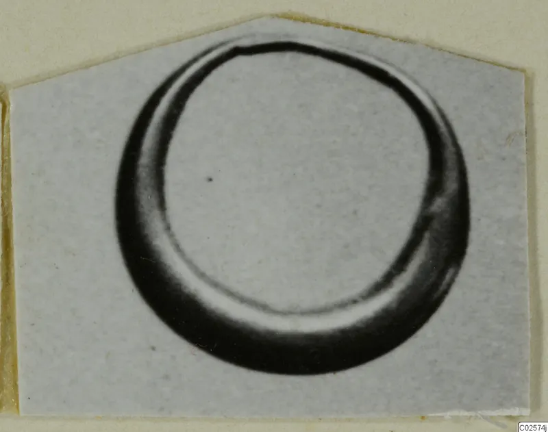 Ring from Enkomi shown in a close view, a thick curved band with an open centre