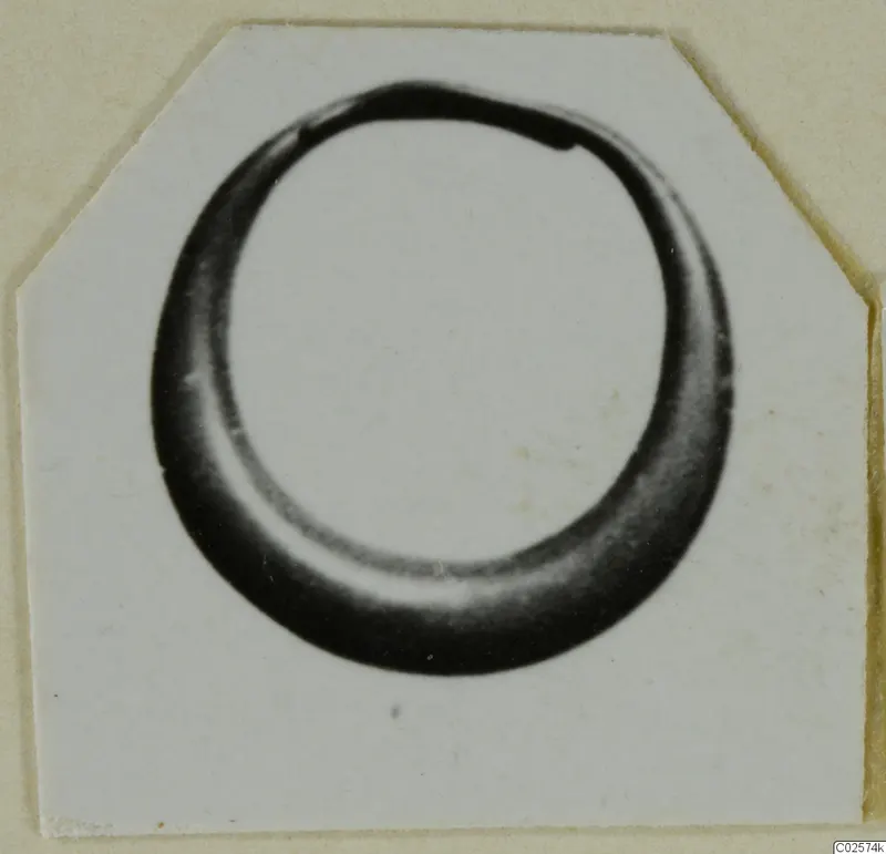 Single gold ring from Enkomi, shown in a close photograph on a card mount