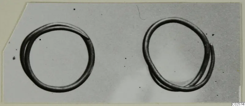 Two thin wire hair-rings photographed side by side against a grey background.