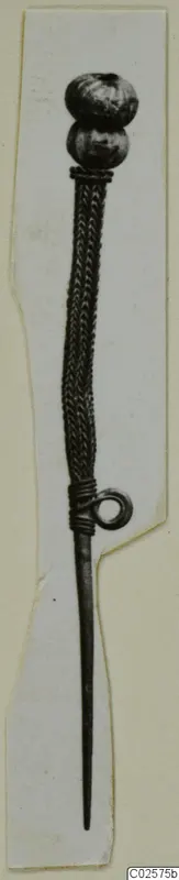 Pin with two round heads at the top, a twisted shank and a wire coil near the thin tapering point