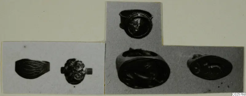 Photographs of five rings from Enkomi, cut out and mounted together on a card