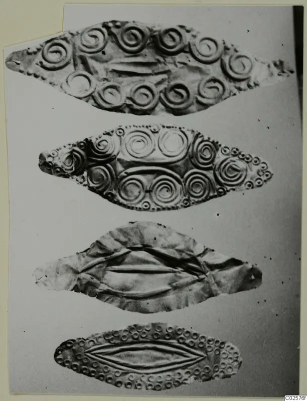 Four leaf-shaped metal ornaments with embossed spirals and dotted borders, from Enkomi