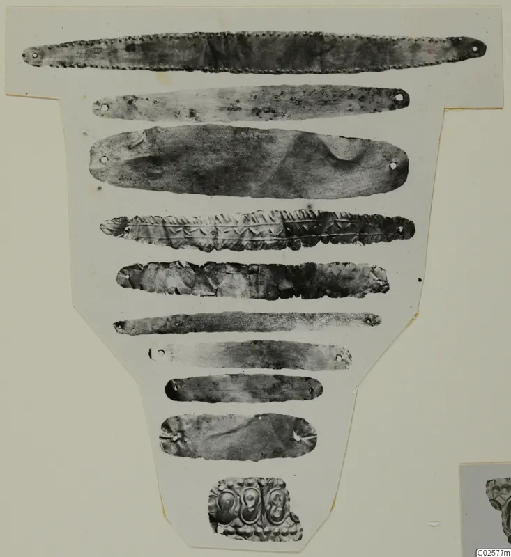 Photo mounted on card of nine narrow metal strips and one embossed fragment, Enkomi finds