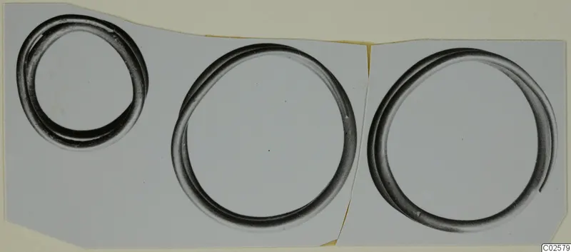 Three metal rings shown together on a pale grey background, Bronze Age gold and silver find from Enkomi