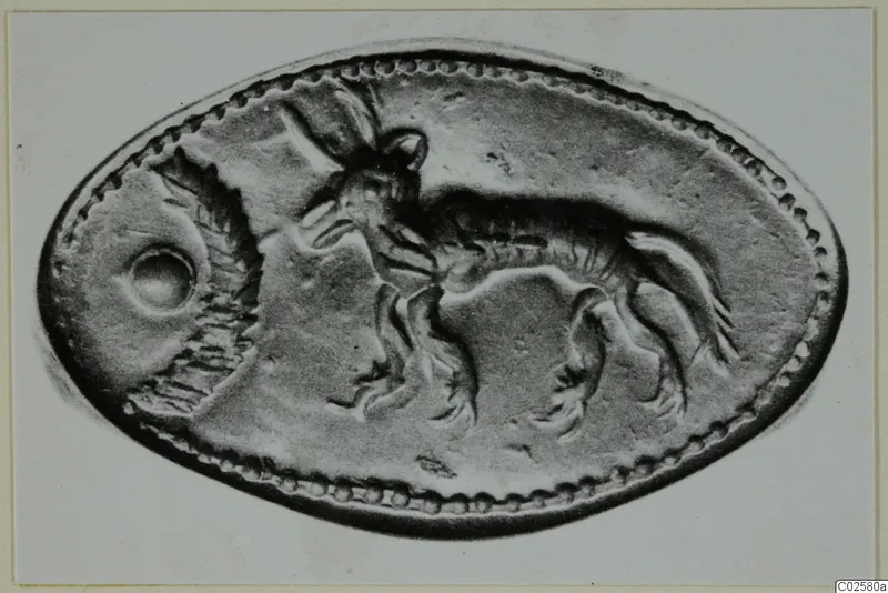 Oval object with a beaded rim and a raised animal design, photographed flat on a pale background.