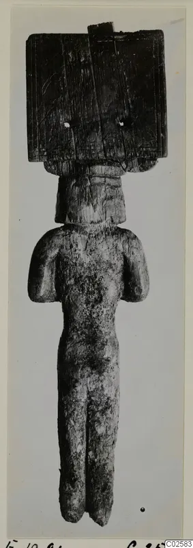 Small carved standing figure with a broad rectangular head block and arms held at its sides, from Enkomi.