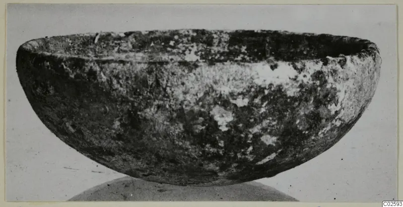 Deep bowl with thick walls and a mottled, weathered surface, from Enkomi small finds.