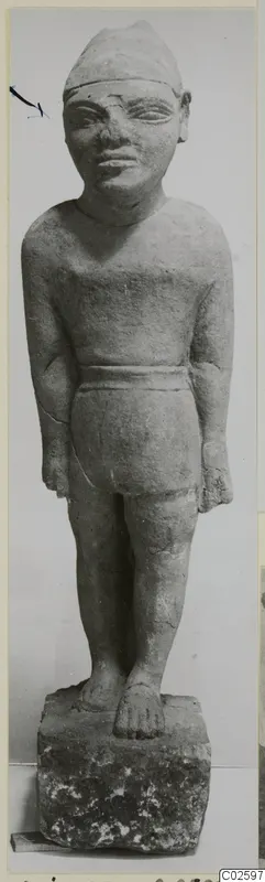 Limestone statue of a standing male figure with arms at its sides and a cap-like headdress, from Ayia Irini