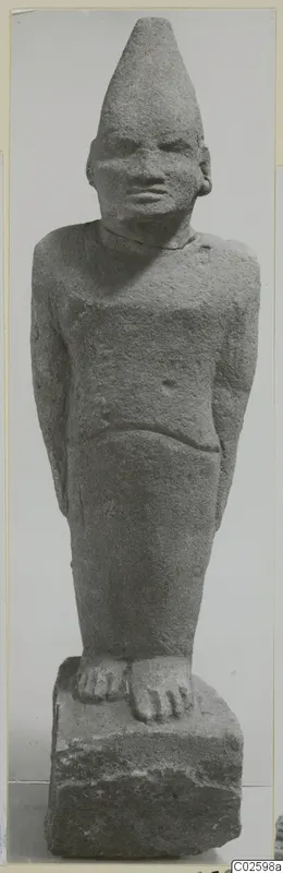Limestone Cypro-Egyptian statue of a standing figure with a tall conical head covering.