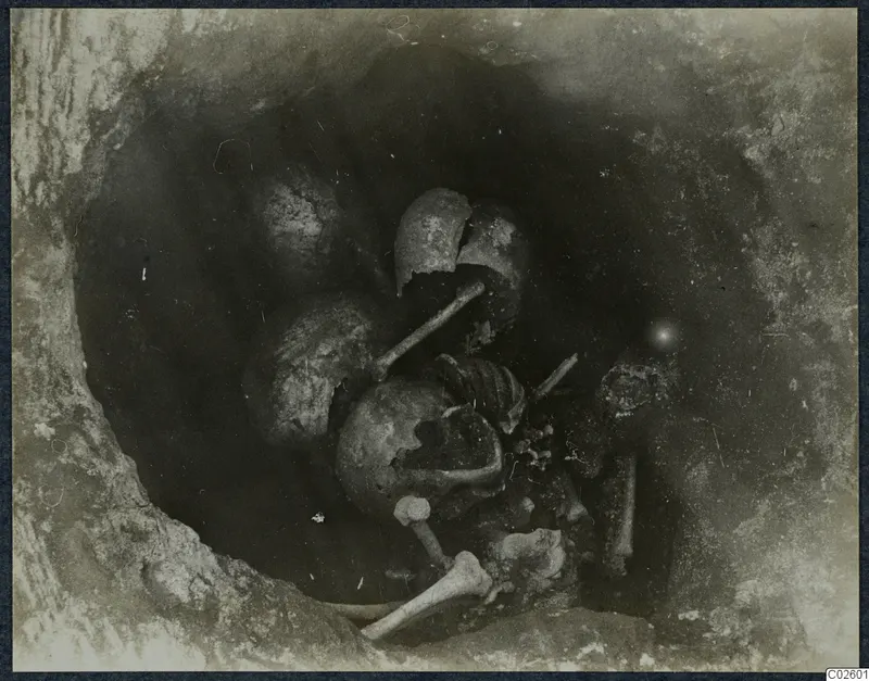 Tomb 6 at Enkomi: skeleton and broken vessels in the tomb chamber during excavation