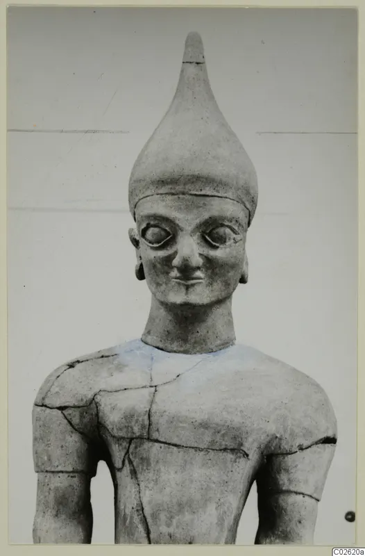 Terracotta Proto-Cypriote II figure: head and upper body with a tall conical headdress and large eyes