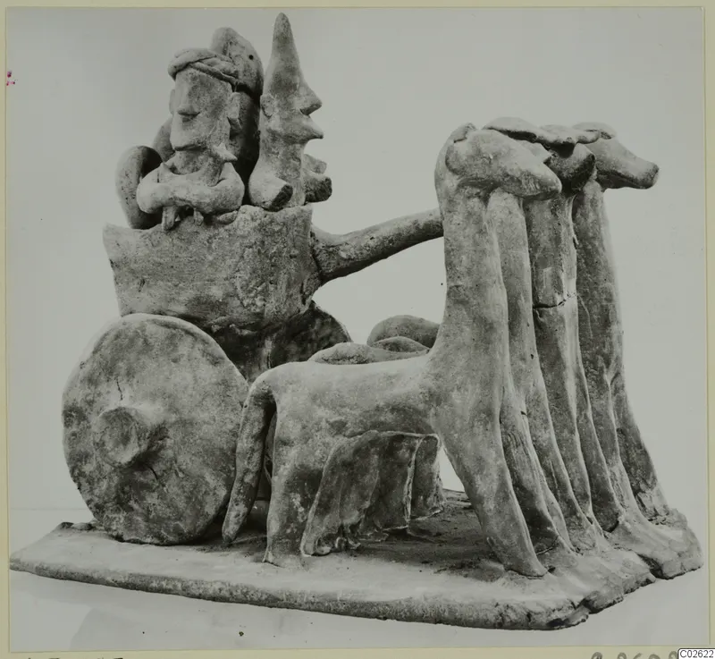 Terracotta model of a two-wheeled cart with seated figures and a team of animals, from Ayia Irini