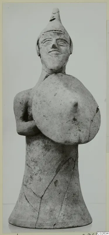 Terracotta figurine of a standing figure holding a round shield, from Ayia Irini