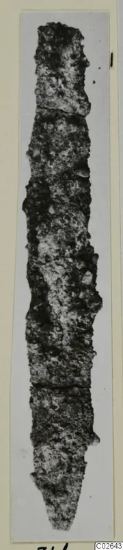 Long, narrow, heavily corroded object tapering to a point, shown upright on a mounted card, from Marion