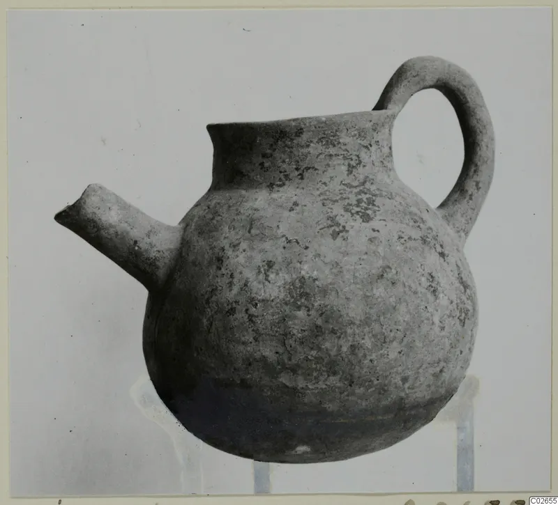 Pottery Black Slip Ware jug with a side spout and loop handle