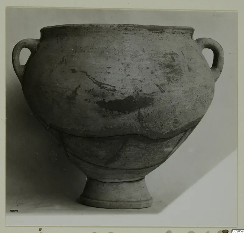 Plain white wheel-made pottery jar with two loop handles and a ring foot