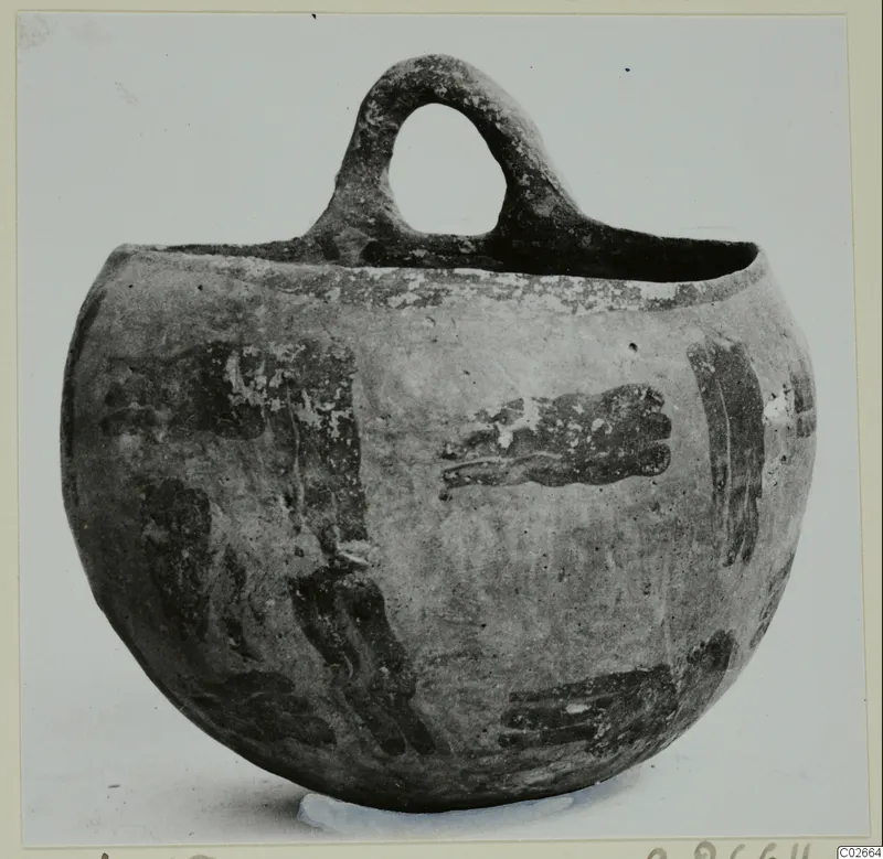 Globular vessel with a single loop handle and dark painted bands and blotches on a pale surface