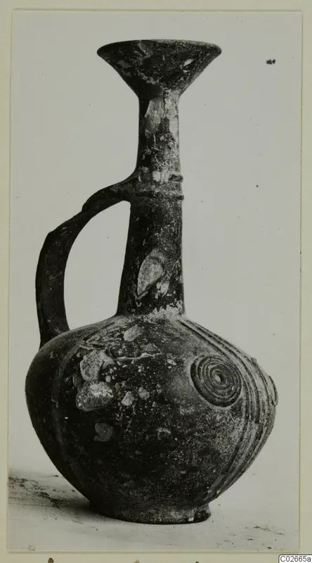 Pottery Base-Ring Ware jug with a trumpet-shaped mouth and a single loop handle
