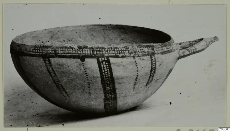 Pottery White Slip Ware bowl with a tubular handle and dark painted bands