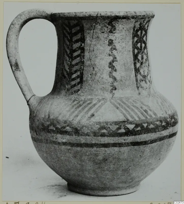 Wheel-made jug with a single loop handle and dark painted chevron, lattice and band decoration, from Ayios Iakovos