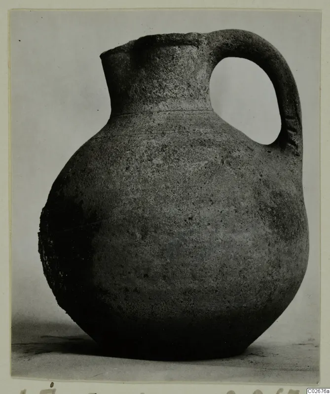 Jug with a rounded body and a single loop handle, from Ayios Iakovos, shown against a plain backdrop