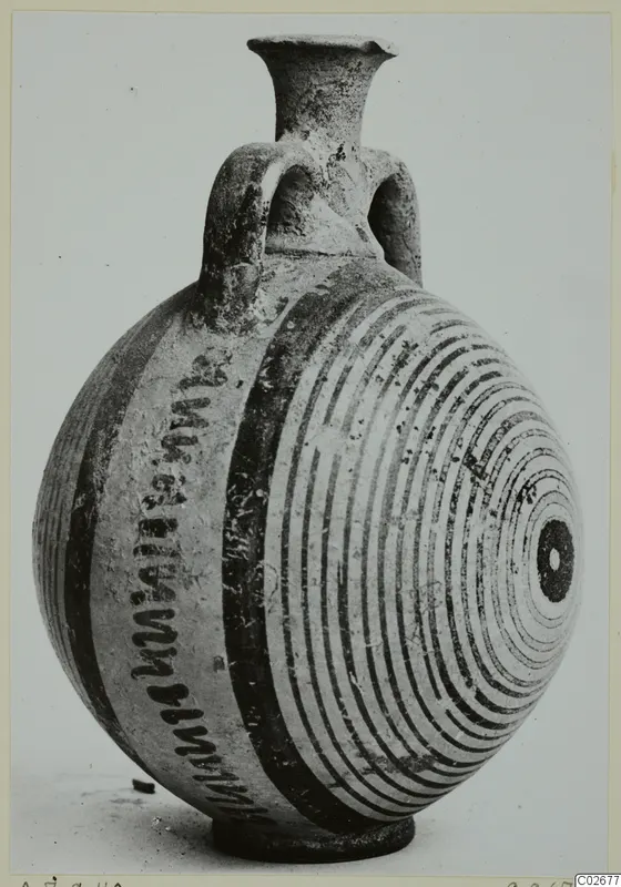 Pottery bottle with a flaring neck, two loop handles and dark painted bands and concentric circles, from Ayios Iakovos