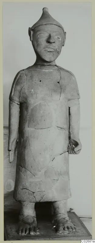 Standing terracotta figure with a conical cap and long tunic, from Ayia Irini