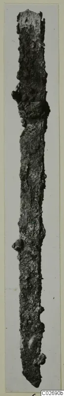 Corroded iron knife from Marion, long and narrow, shown upright