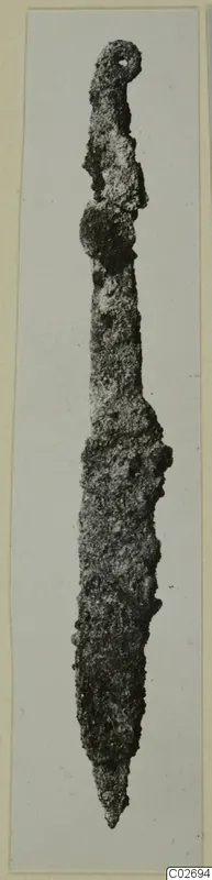 Corroded iron knife-like tool from Marion, photographed on a card mount.
