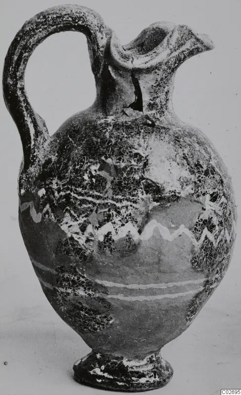 Jug with a loop handle, trefoil mouth and white zigzag and horizontal bands on the body, shown on a plain background
