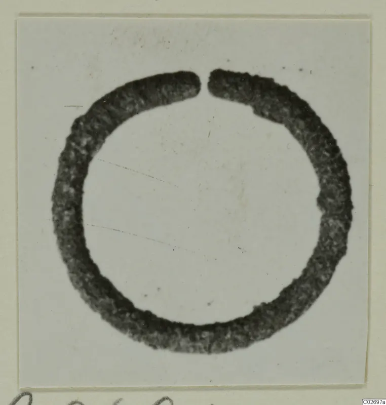 Single open bronze ring from Marion Tomb 85, photographed on a mounted card.