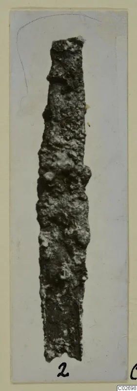 Corroded iron knife blade from Marion Tombs 6 A and 6 B, shown on a mounted card.