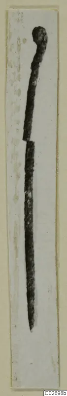 Bronze pin from Marion Tomb 9, broken across the shaft, shown upright on a pale card strip