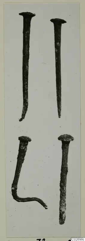 Four corroded nails with flat heads, one bent at the tip and one bent into an L-shape, from Tomb 16 at Marion