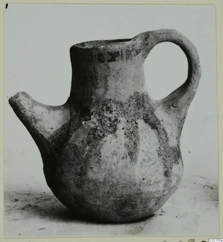 Pottery jug with a side spout and loop handle, White Painted IV-V, shown on a plain background.
