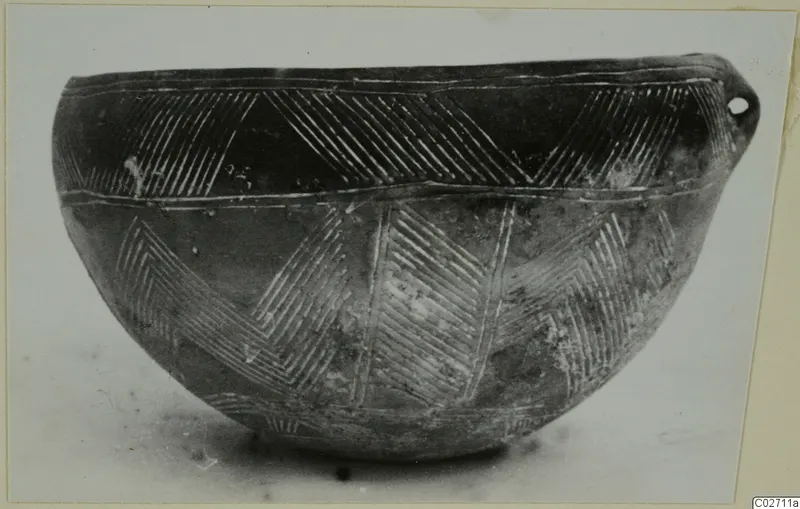 Pottery Red Polished II bowl from Lapithos with incised chevron bands and a small pierced lug