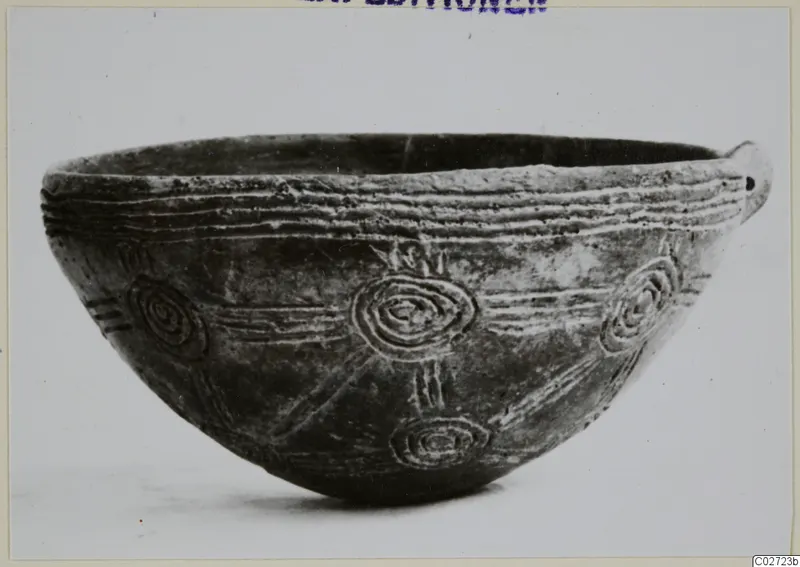 Pottery Red Polished III Bowl from Lapithos, shown in profile with incised concentric circles and lines