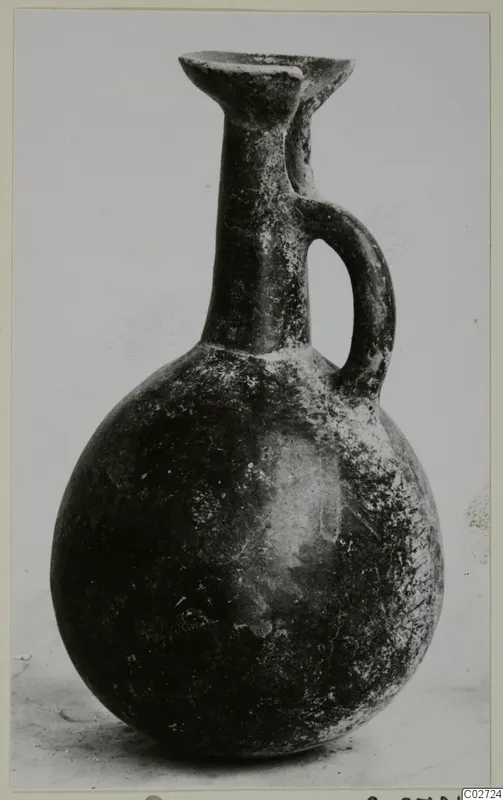 Pottery Red Polished III jug from Lapithos, with a single loop handle and a rounded body