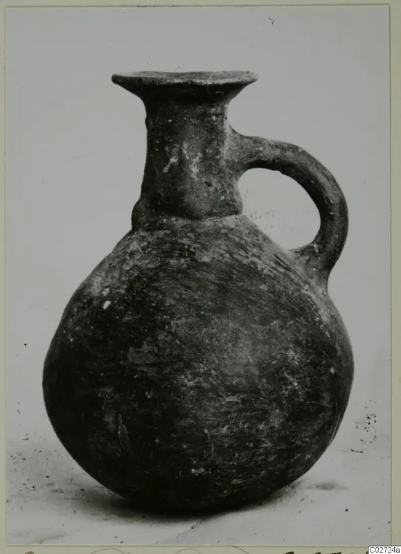 Red Polished III jug from Lapithos, Vrysi tou Barba tombs, with a flaring rim and a single loop handle.