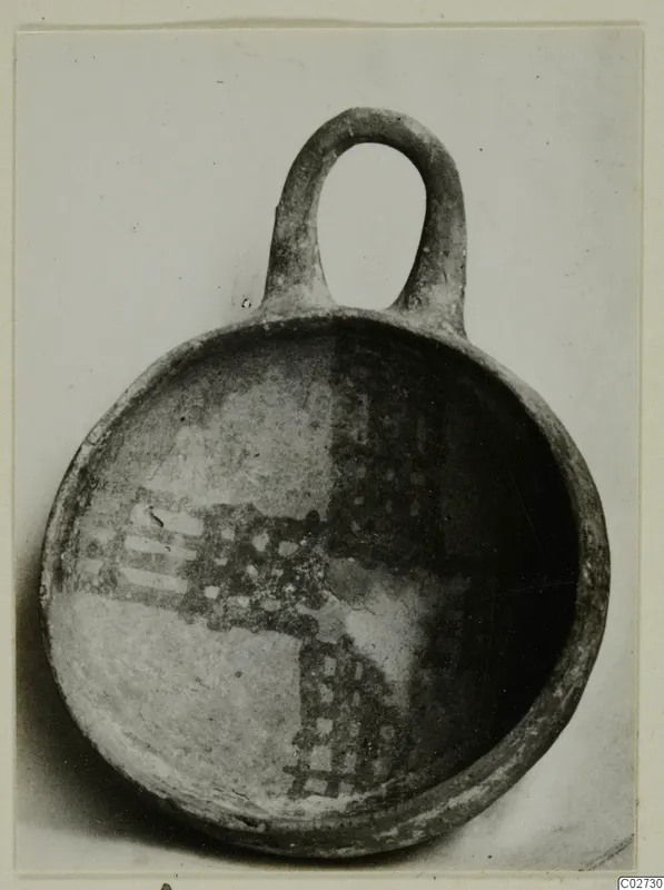 White Painted IV-V bowl from Ayios Iakovos with a loop handle and dark painted checkered and banded decoration