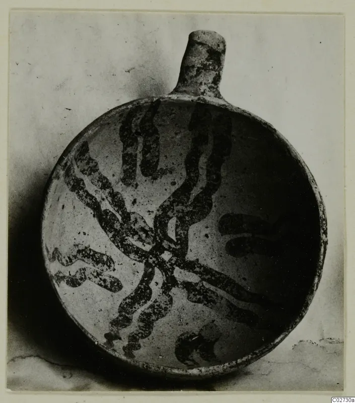 White Painted IV-V bowl from Ayios Iakovos, with a dark wavy painted design on a pale surface