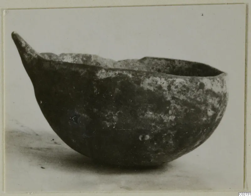 Black Slip Ware bowl with a pointed handle, seen from the side