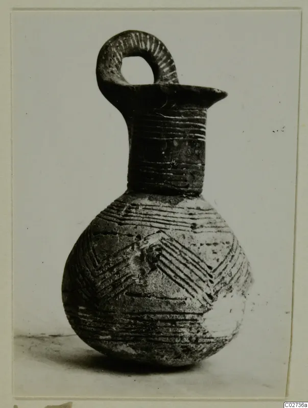 Red Polished III jug from Amathus, with a looped handle and incised bands and chevron decoration