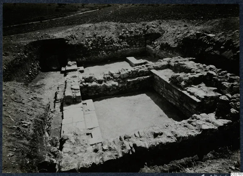 Excavated stone construction at Soli, Cholades, with a track running across the field behind it