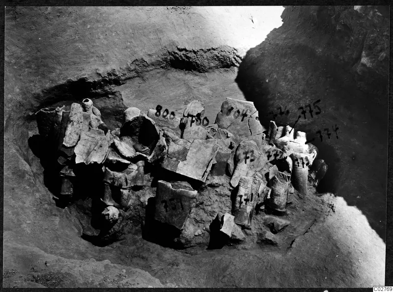 Broken stone statues and fragments lying in excavation pit H 14-15 at Mersinaki
