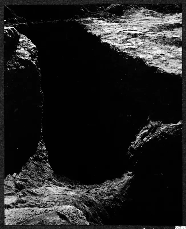 Pit C 8 at Mersinaki after excavation, with rough cut sides and a stony floor in deep shadow
