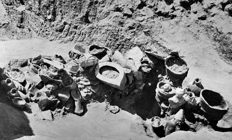 Pottery vessels and figure fragments lying in situ in excavated pit H 14-15 at Mersinaki