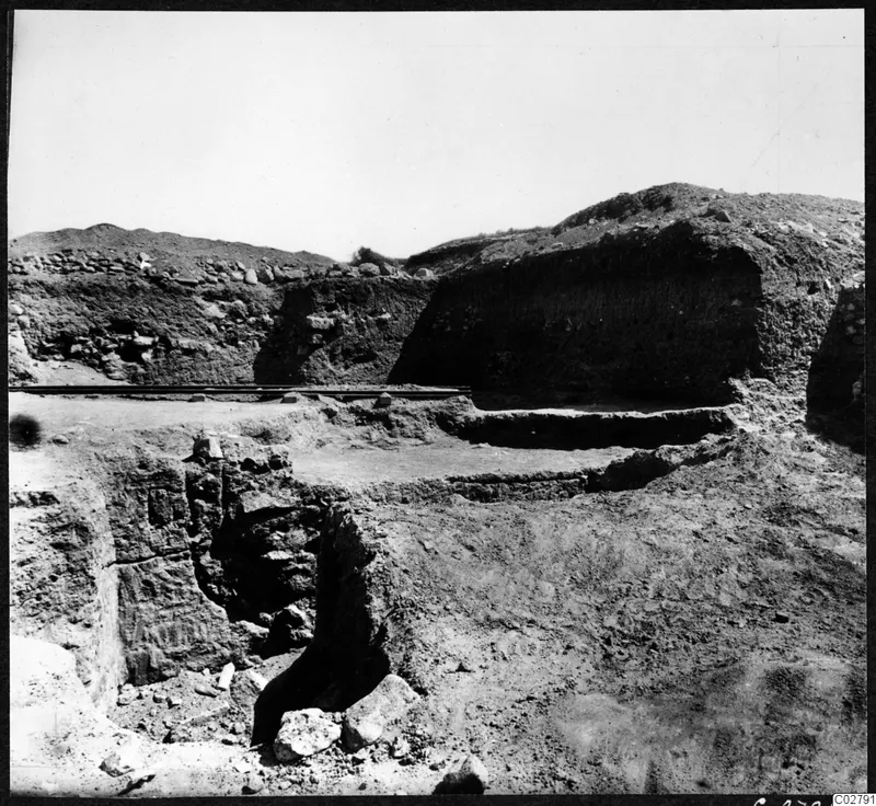 Excavation at Mersinaki showing deep trenches, exposed walls and a rail line across the dig.