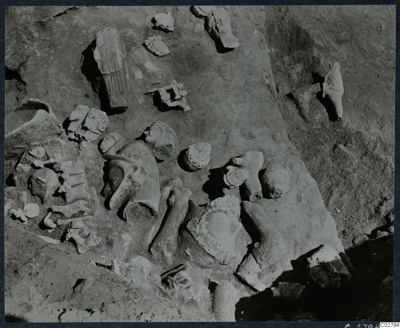 Statue fragments and heads lying in excavated soil at Mersinaki, heads of different sizes